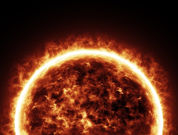 Close-up of the sun's fiery surface with visible solar flares.