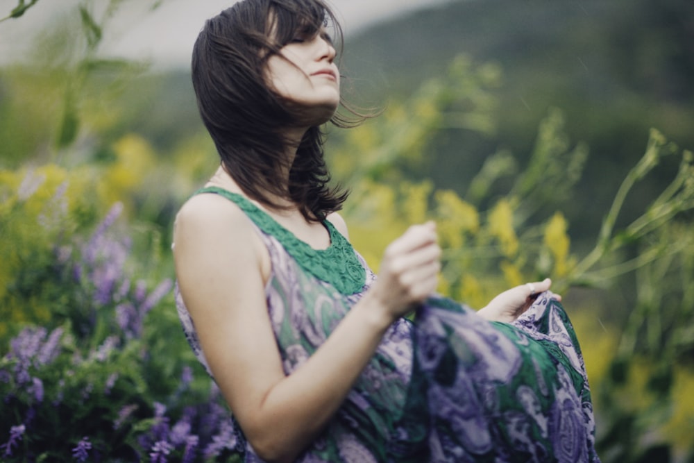 a woman standing in a field of flowers