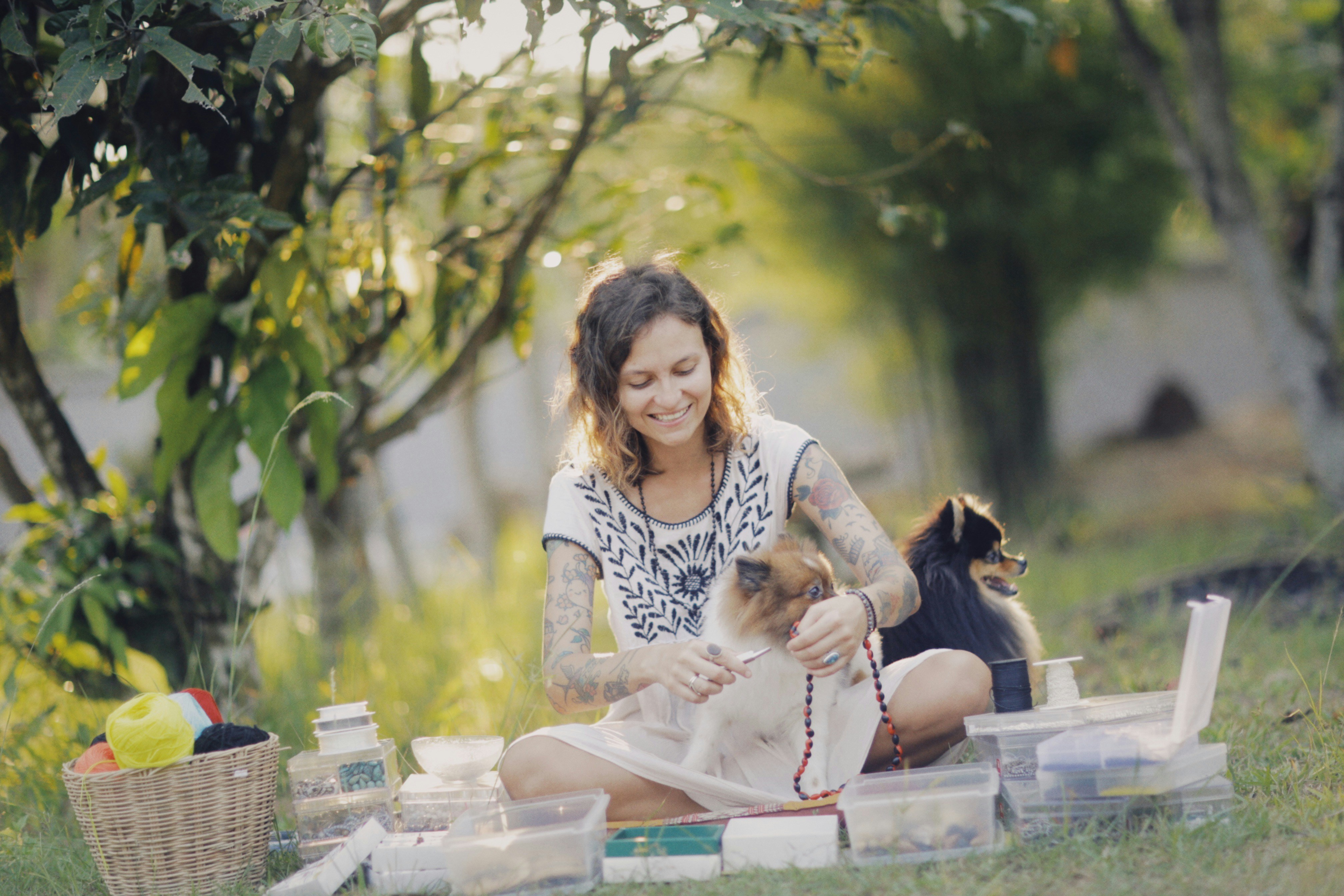 a woman sitting on the ground with a dog