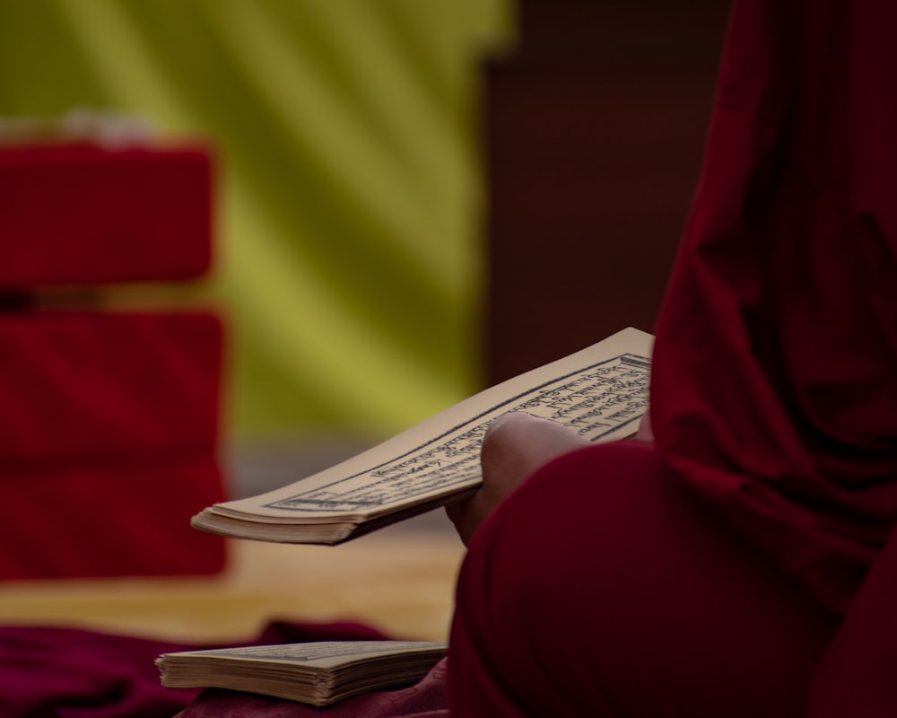 a person sitting on the floor reading a book