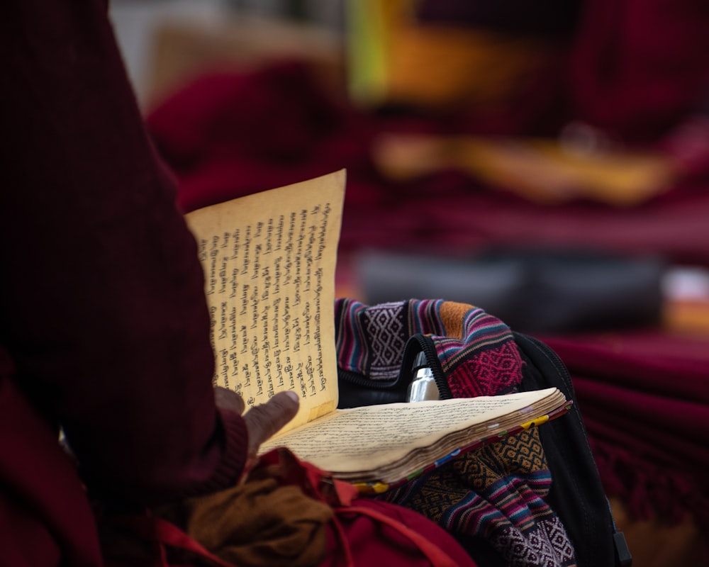 a person holding a book in their lap