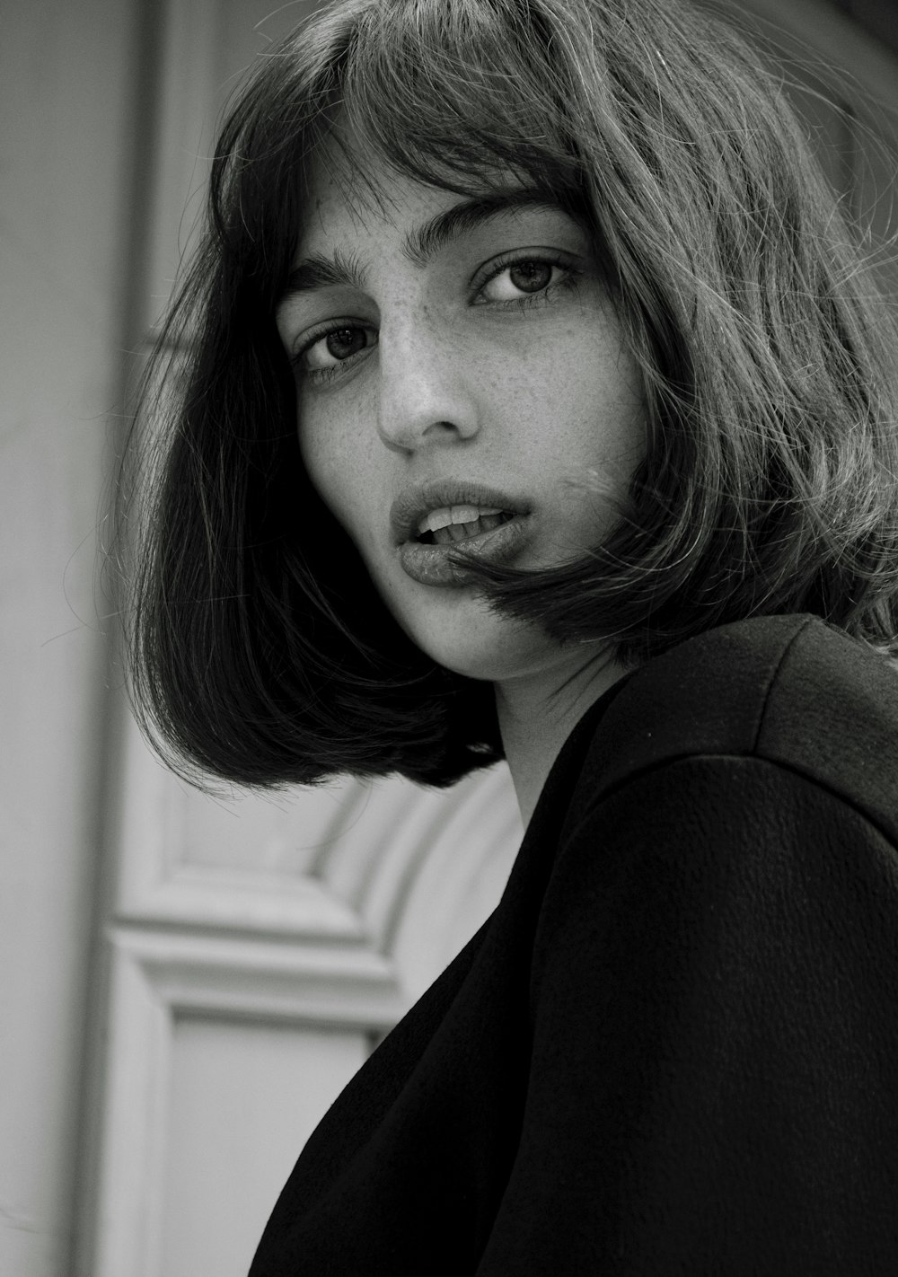 a black and white photo of a woman with a moustache