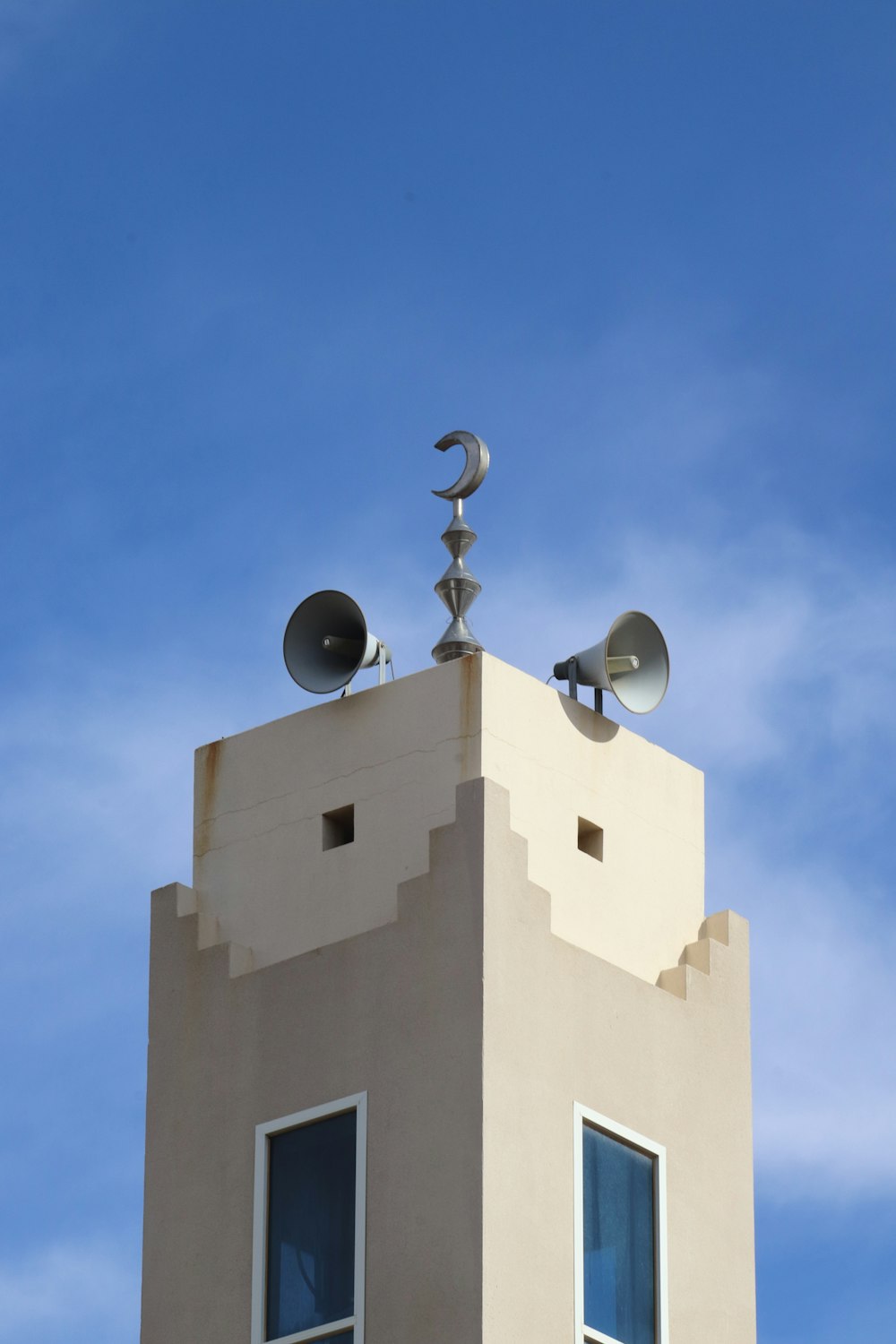 a tall building with a weather vane on top of it