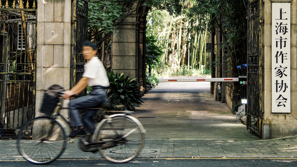 a man riding a bike down a street