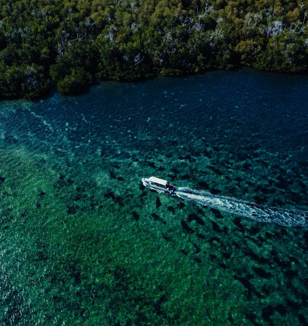 an aerial view of a boat in a body of water