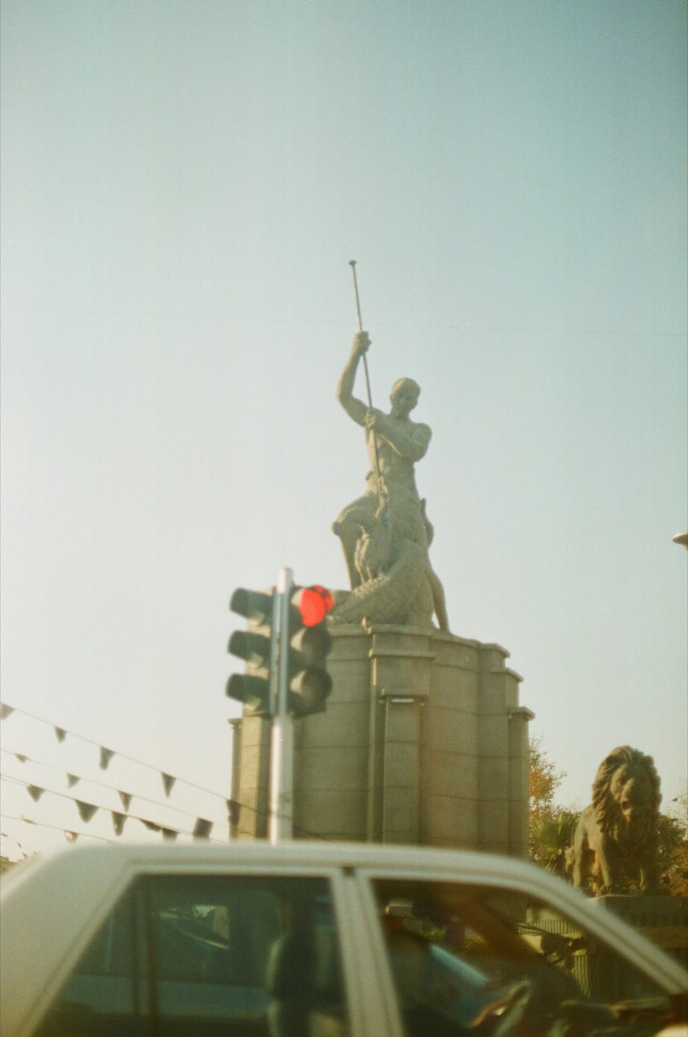 a traffic light with a statue on top of it