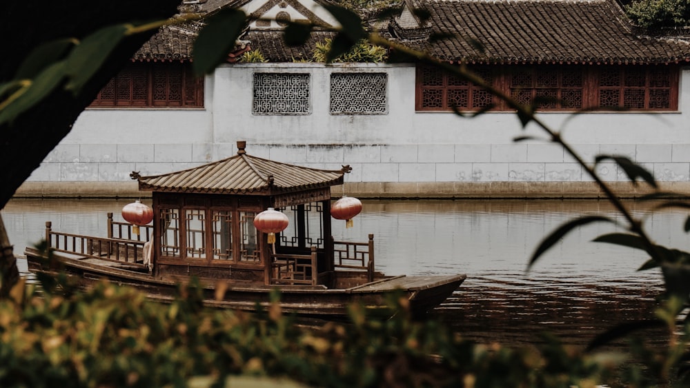 a boat floating on top of a river next to a building