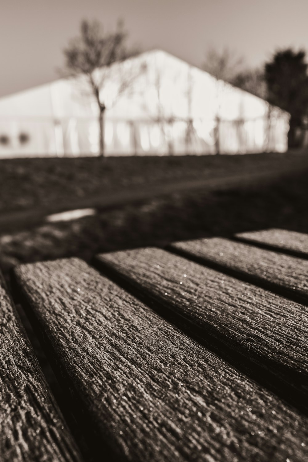 a black and white photo of a wooden bench