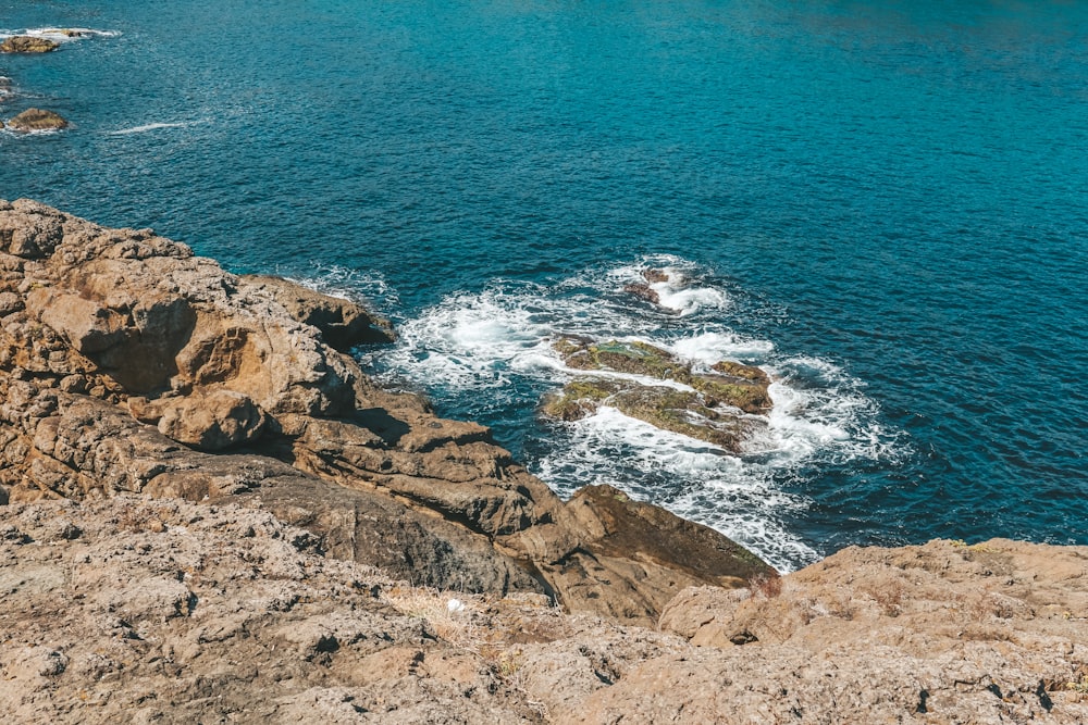 a rocky cliff overlooks a body of water