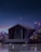 A modern, minimalist house with large windows is set against a serene night sky with a crescent moon. The house is surrounded by dreamy, glowing foliage and sits on the edge of a reflective body of water.