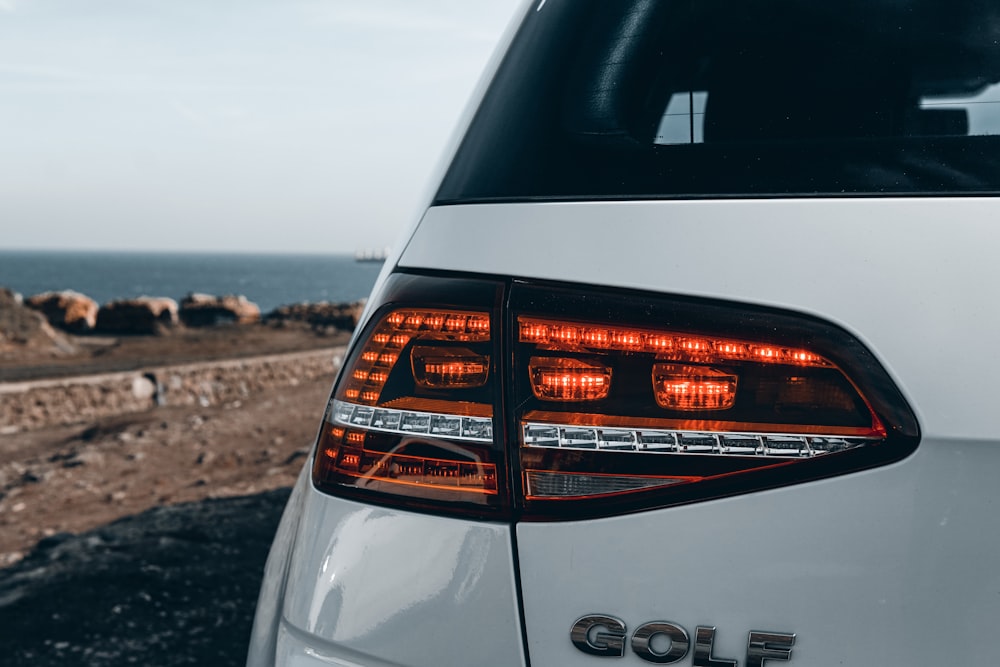 the tail lights of a white golf car