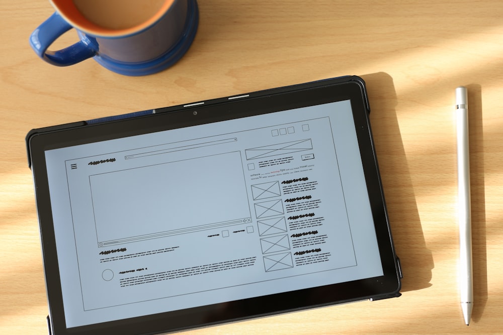 a tablet computer sitting on top of a wooden table