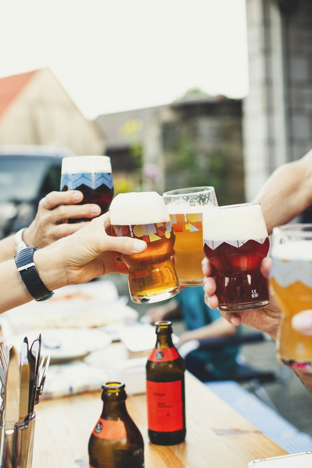 a group of people holding glasses of beer