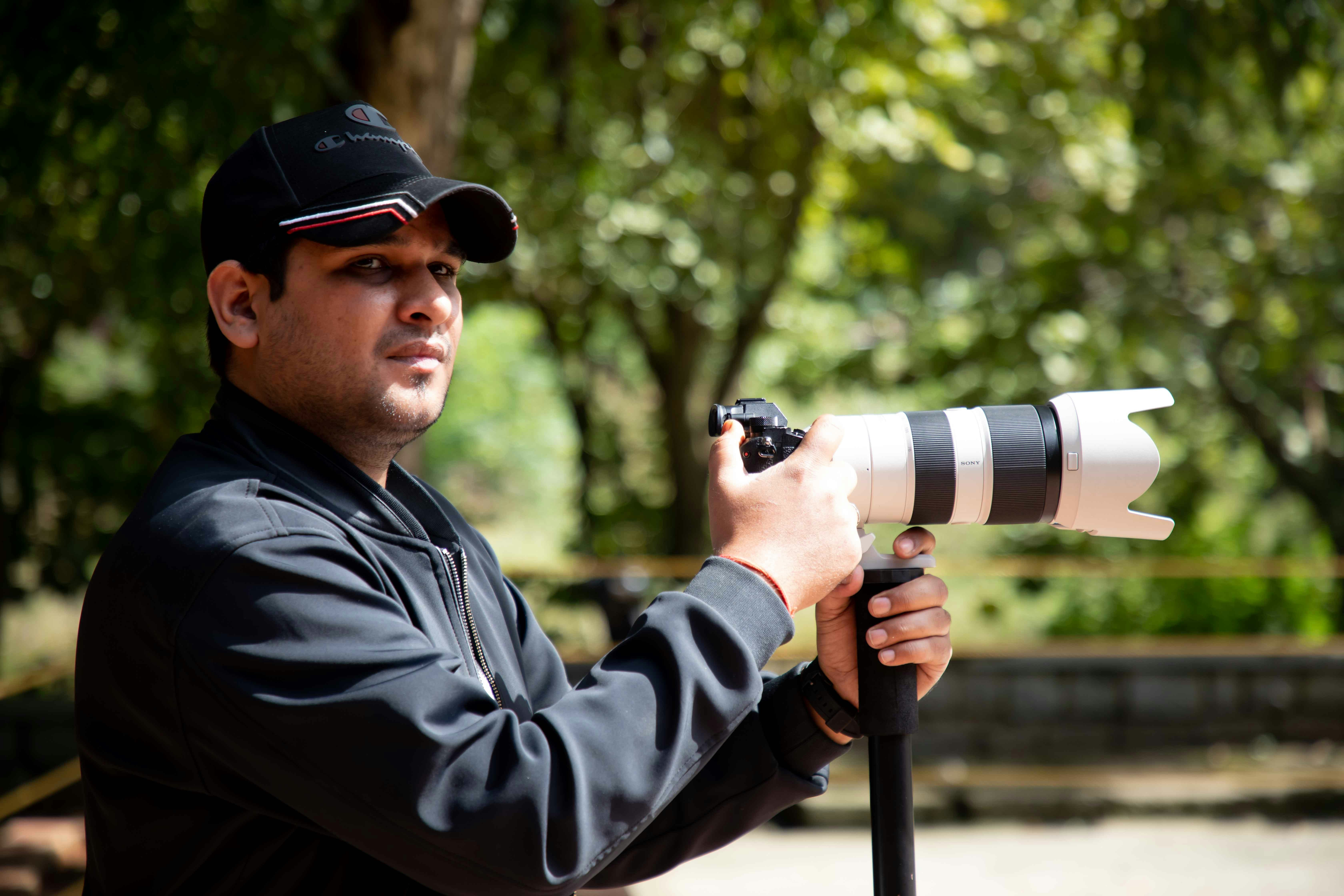a man is holding a camera and taking a picture
