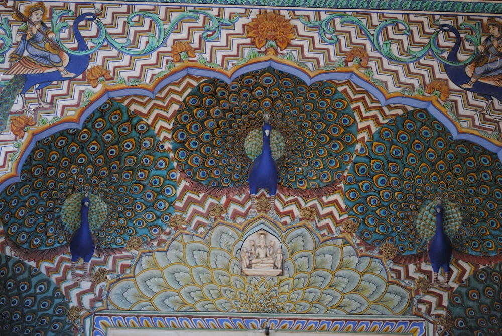 peacocks are painted on the wall of a building