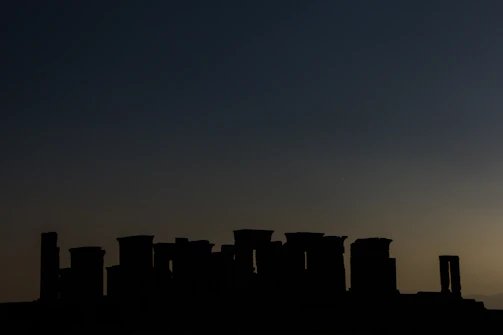 Mysterious silhouette of a Mesopotamian warrior against a twilight sky.