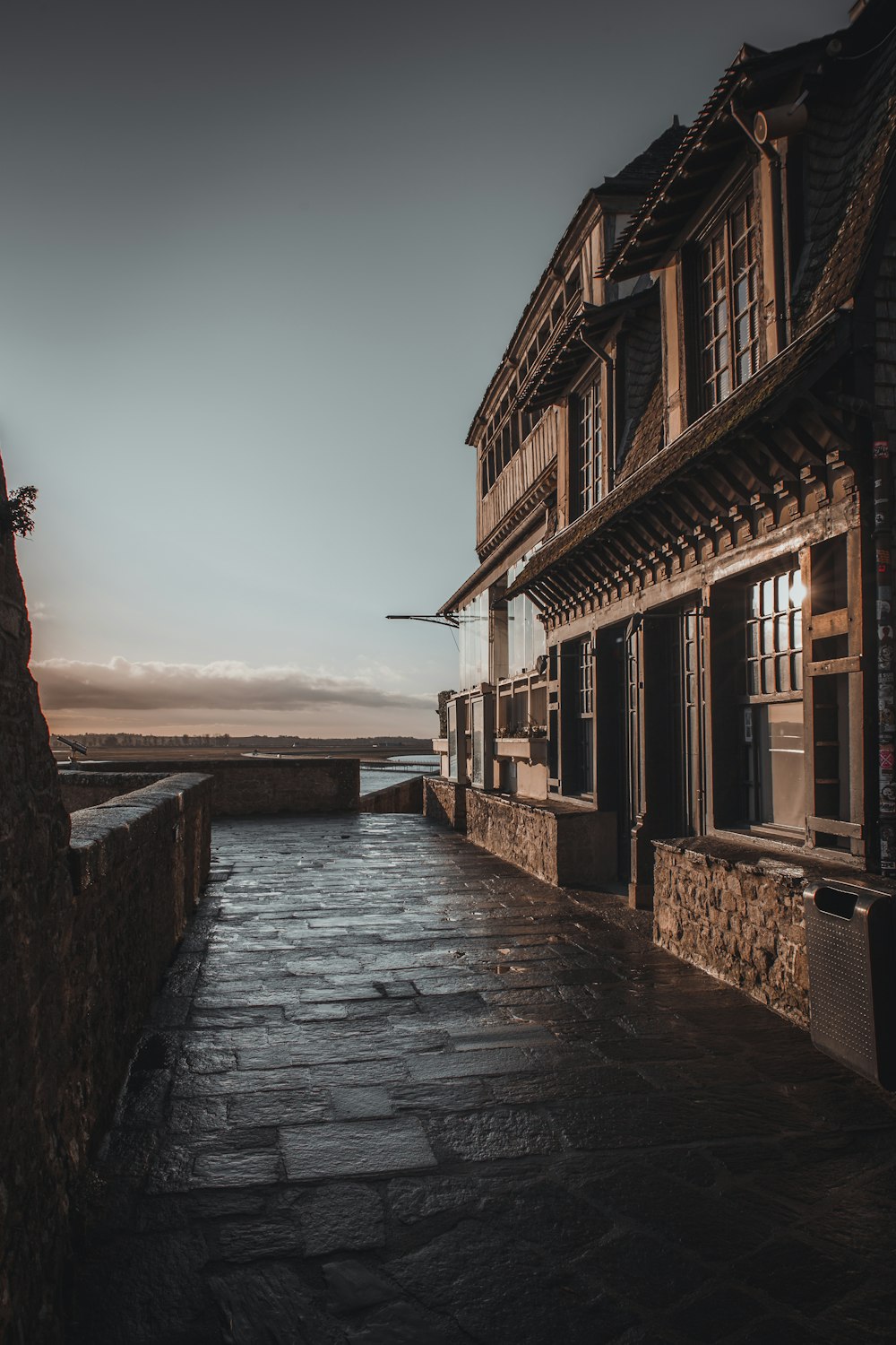 a cobblestone walkway leading to a building