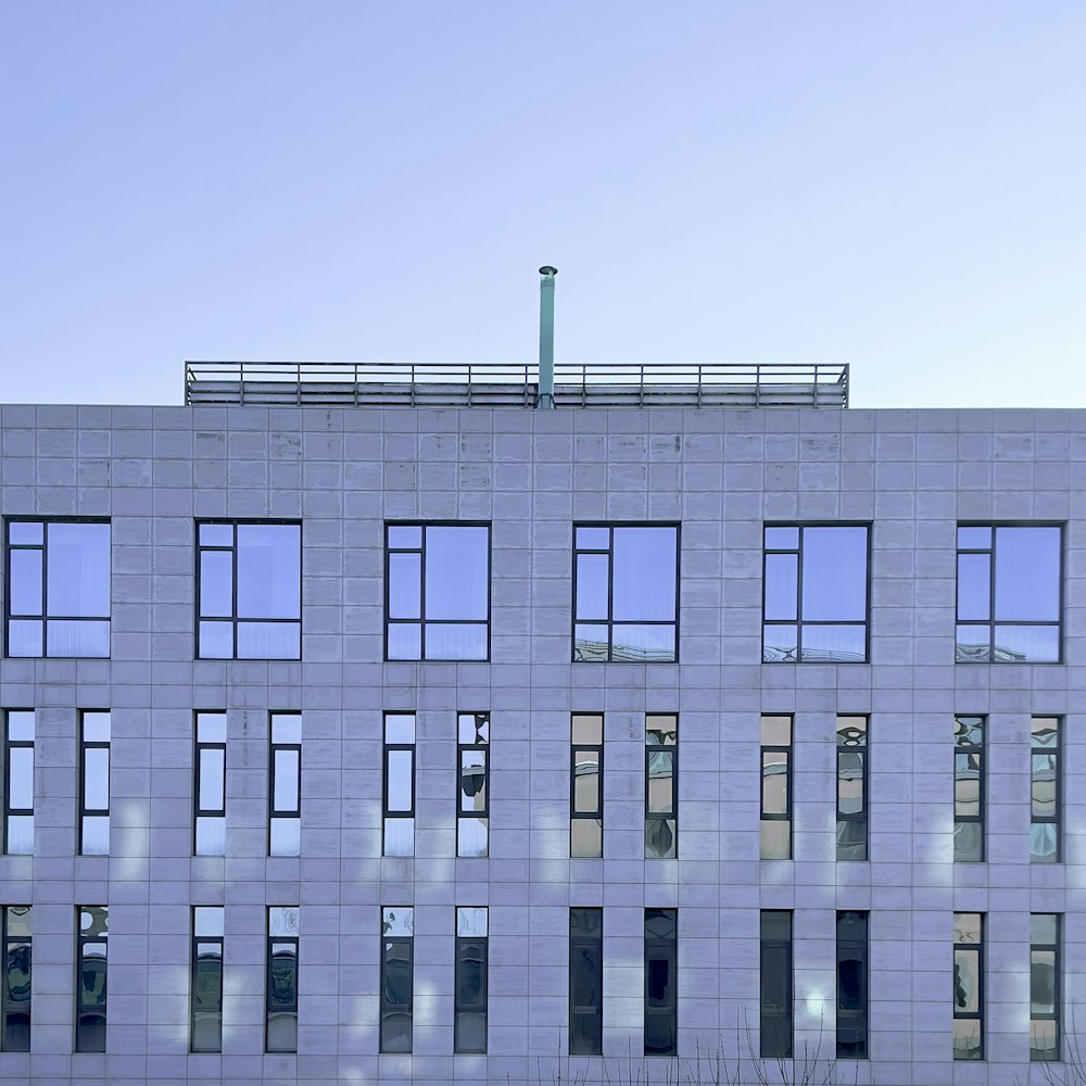 a large white building with many windows and a clock