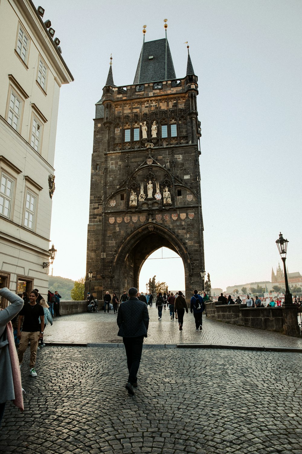 a group of people walking down a cobblestone street