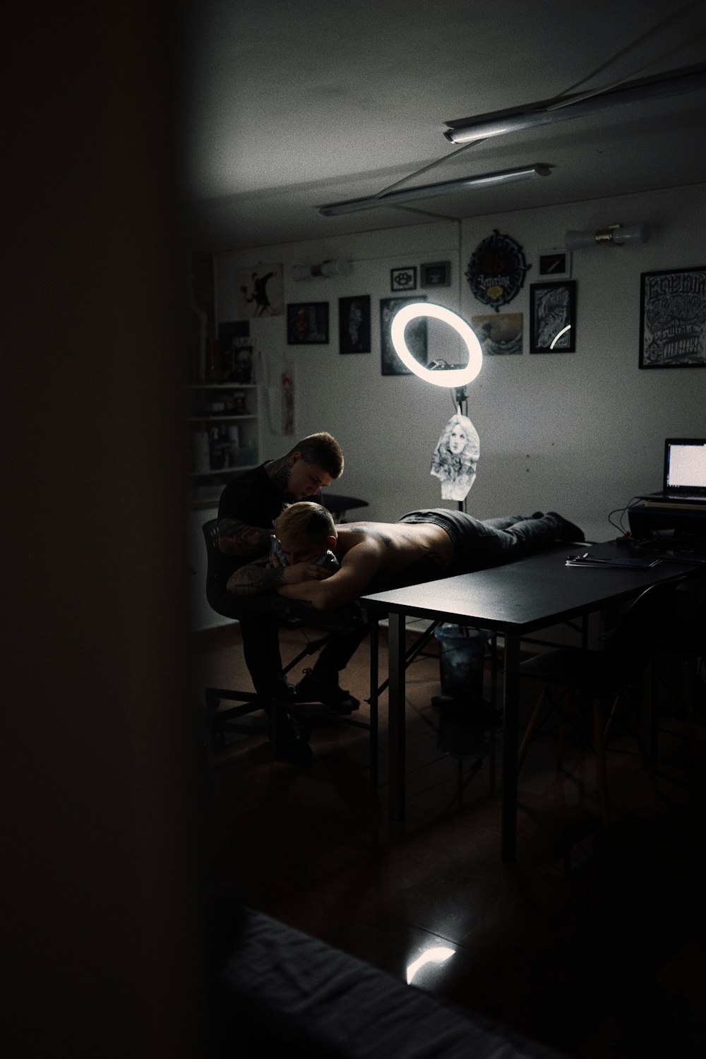 a man sitting at a table in a dark room