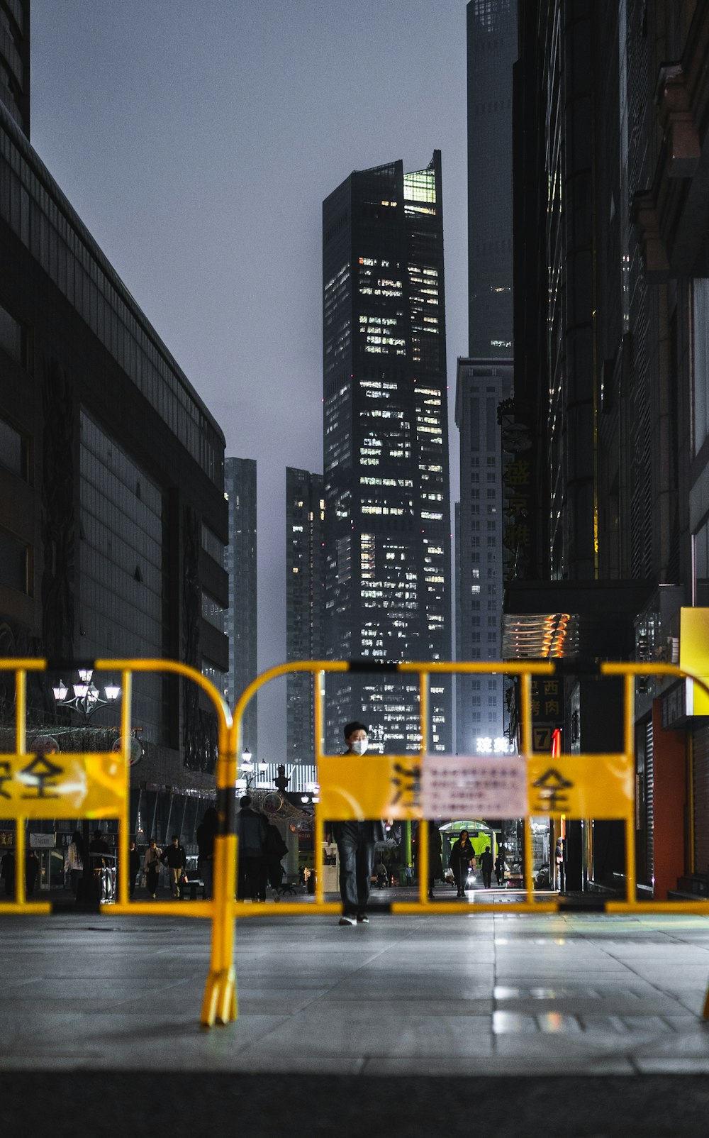 a yellow barricade in a city at night