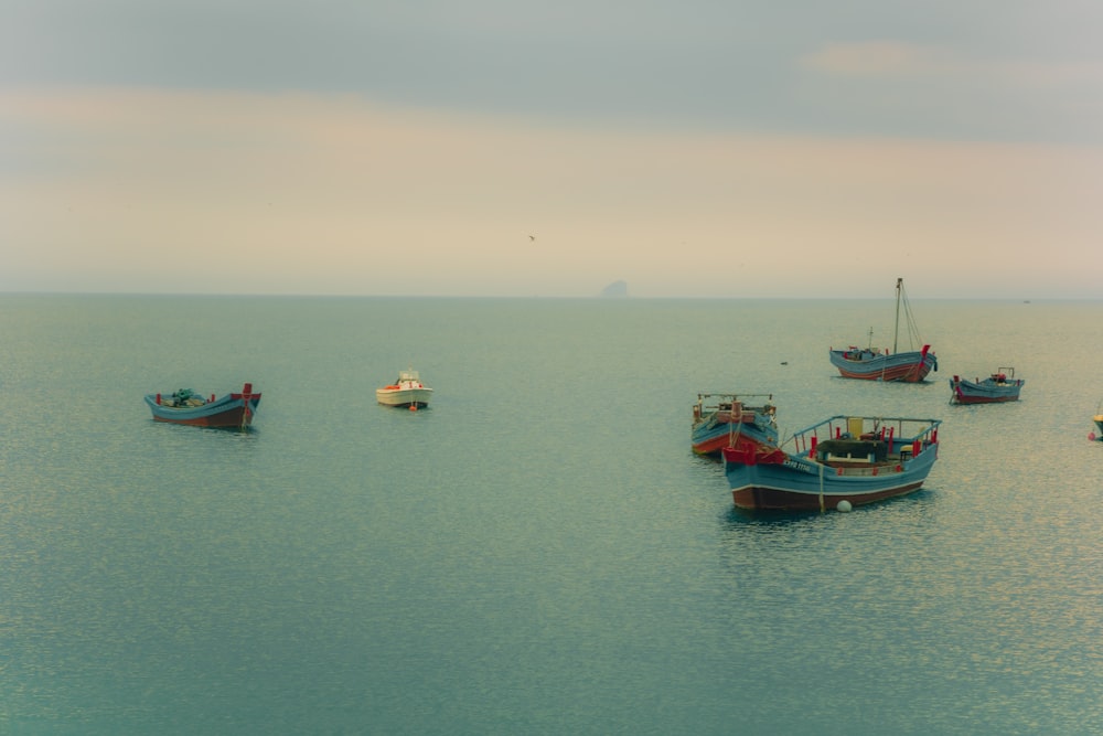 a group of boats floating on top of a large body of water