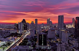 a view of a city at sunset from the top of a building