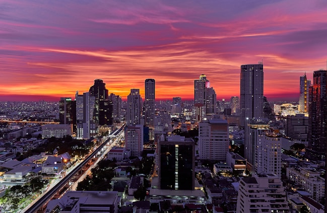 a view of a city at sunset from the top of a building