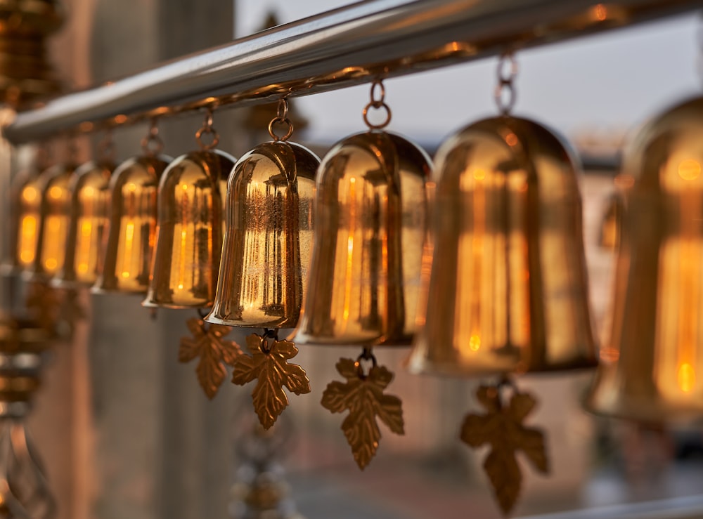 a group of bells hanging from a metal bar