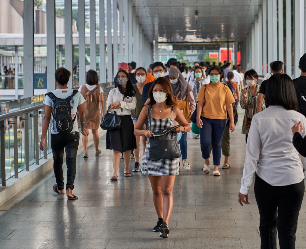 a group of people walking down a walkway