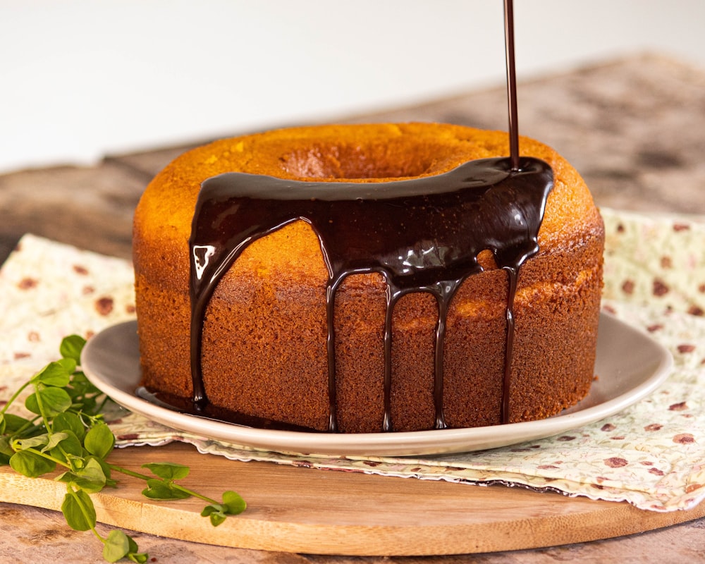 a bundt cake with chocolate icing on a plate