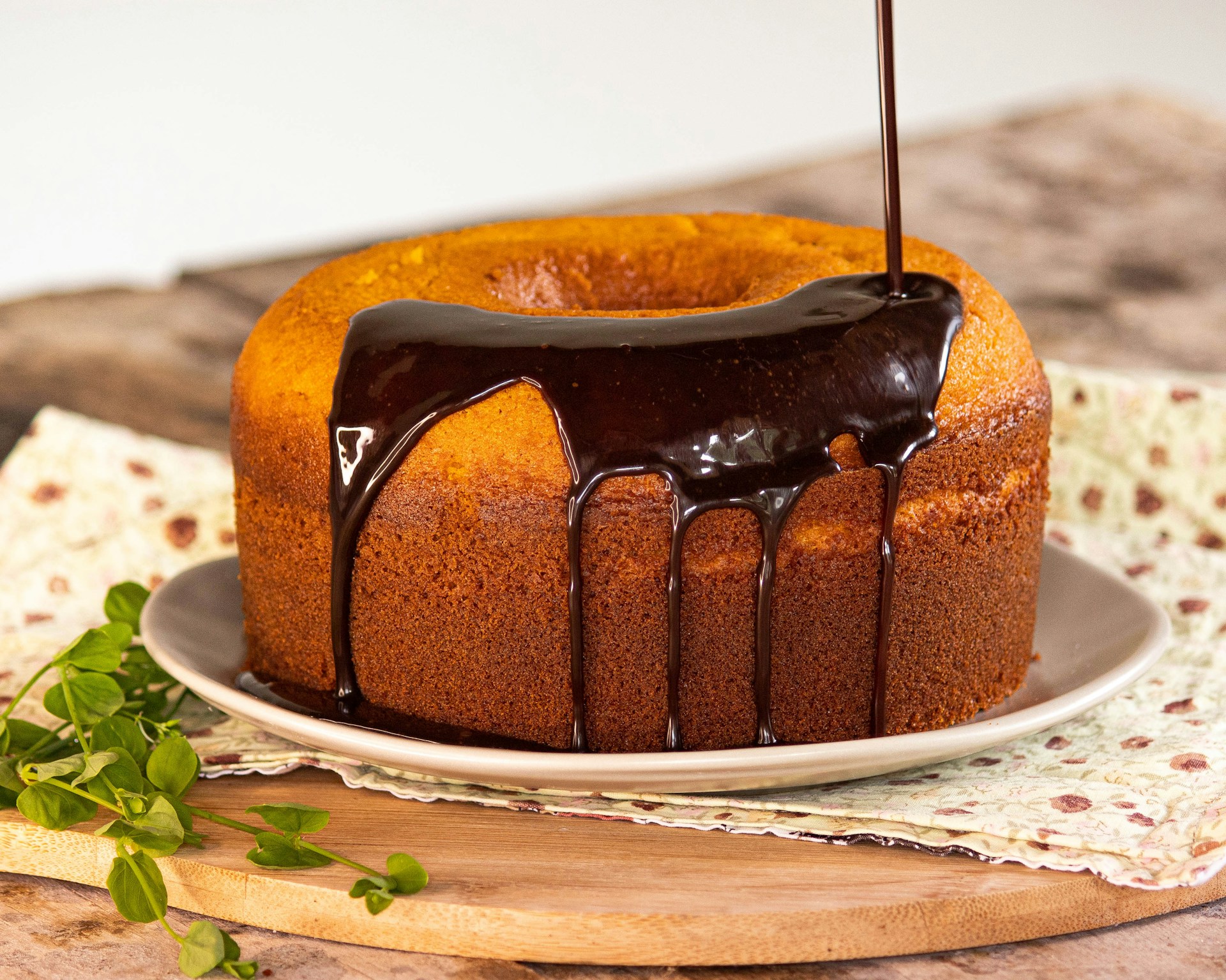 a bundt cake with chocolate icing on a plate