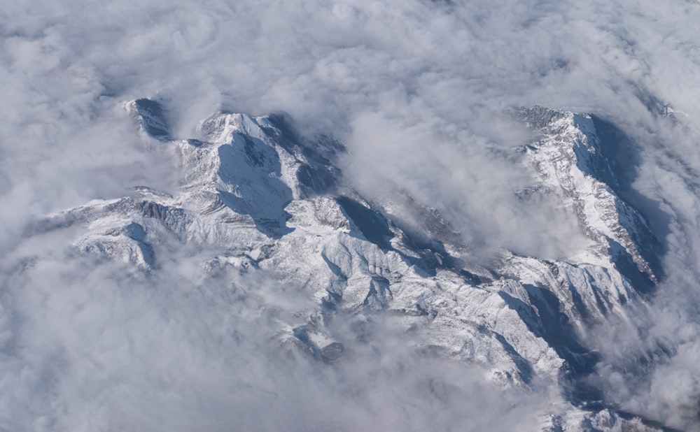 a view of a snow covered mountain from an airplane