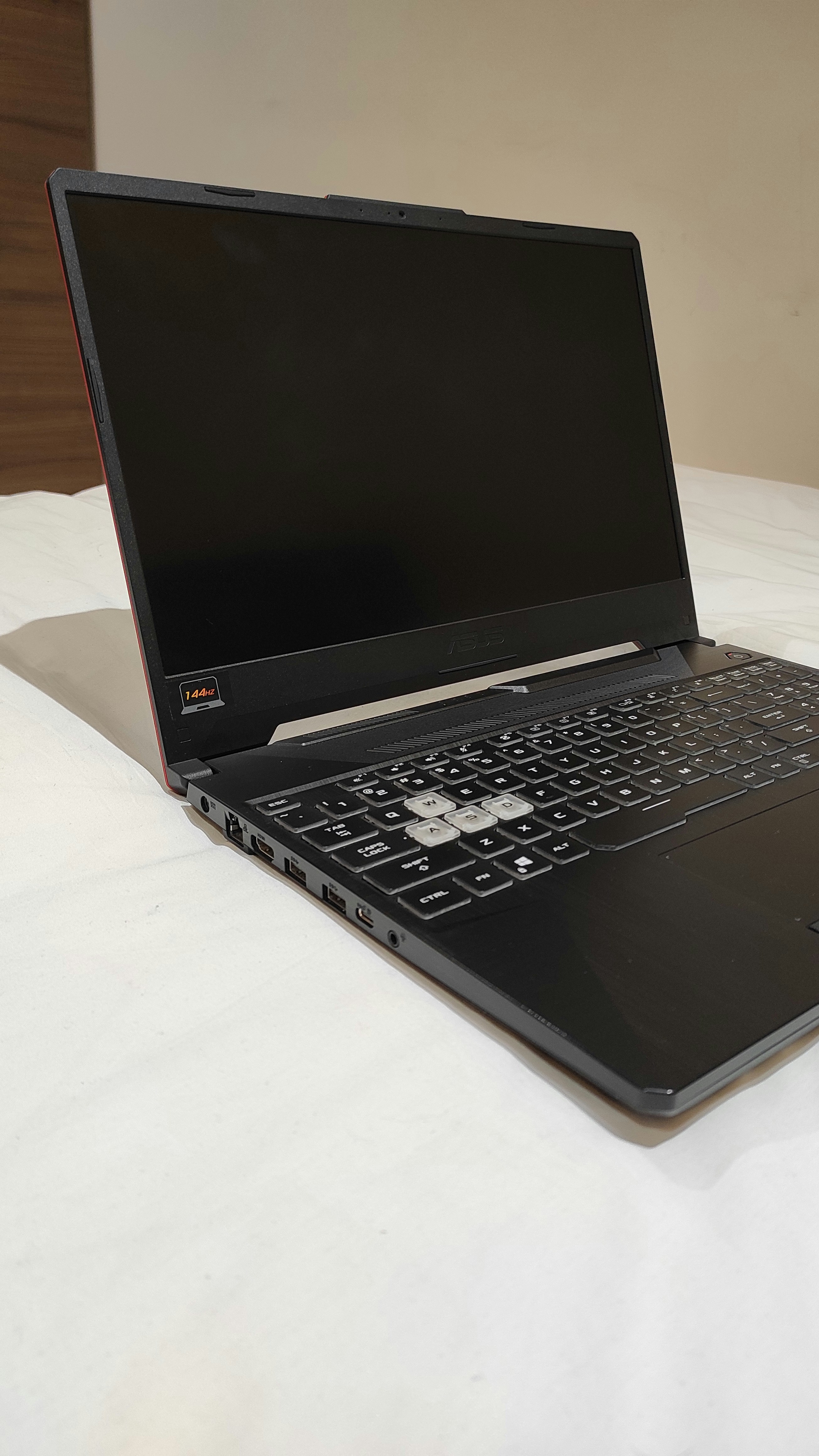 Asus TUF Gaming F15 black gaming laptop open showing RGB keyboard and display