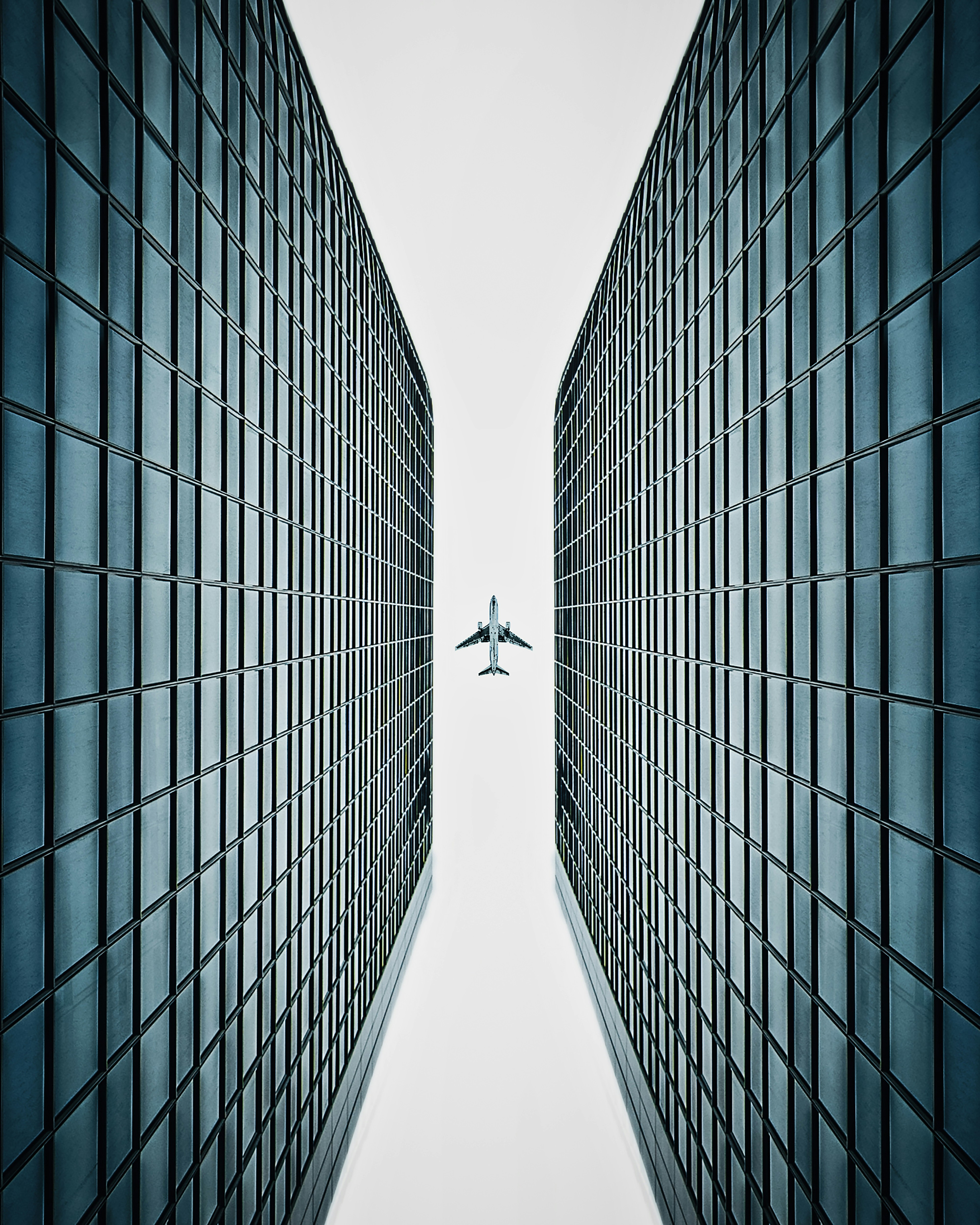 an airplane flying over a tall building in the sky
