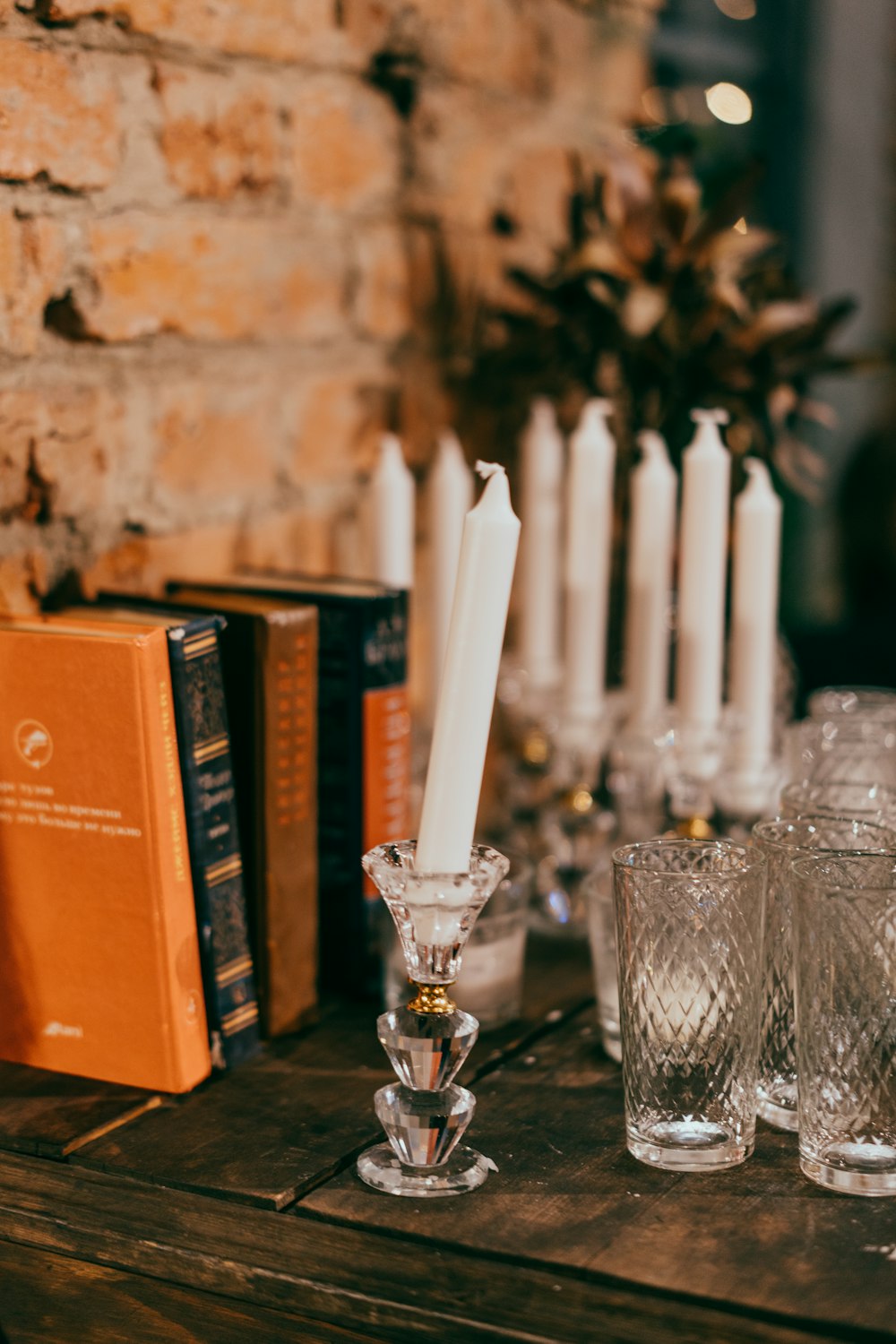 a wooden table topped with glasses and candles