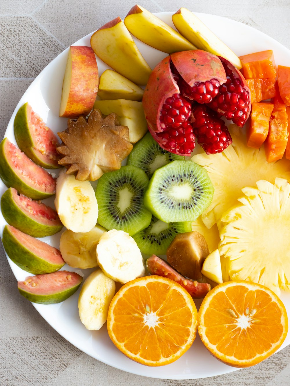 a white plate topped with cut up fruit