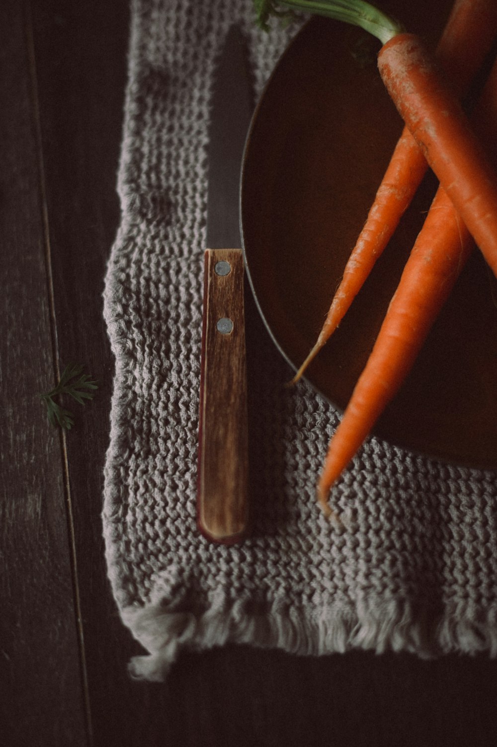 a plate of carrots and a knife on a table