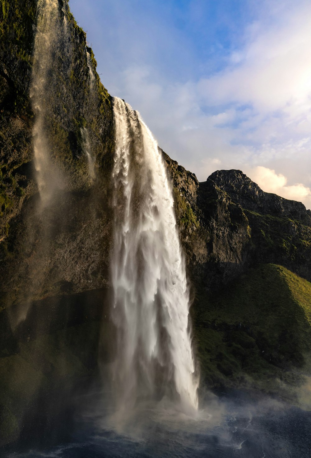 a very tall waterfall with lots of water coming out of it