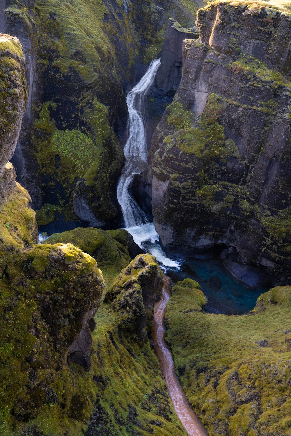 a river running through a lush green valley