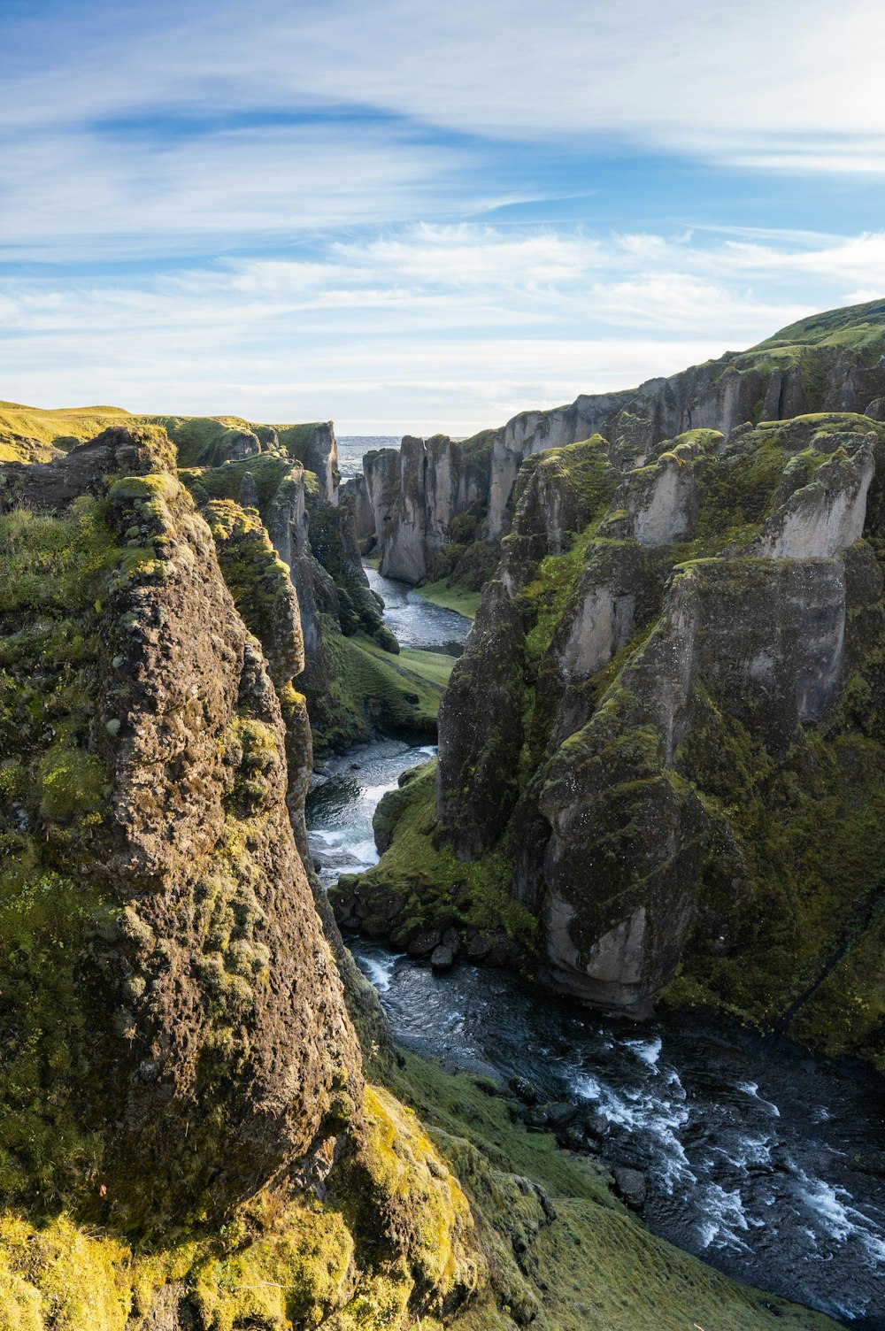 a river running through a lush green valley