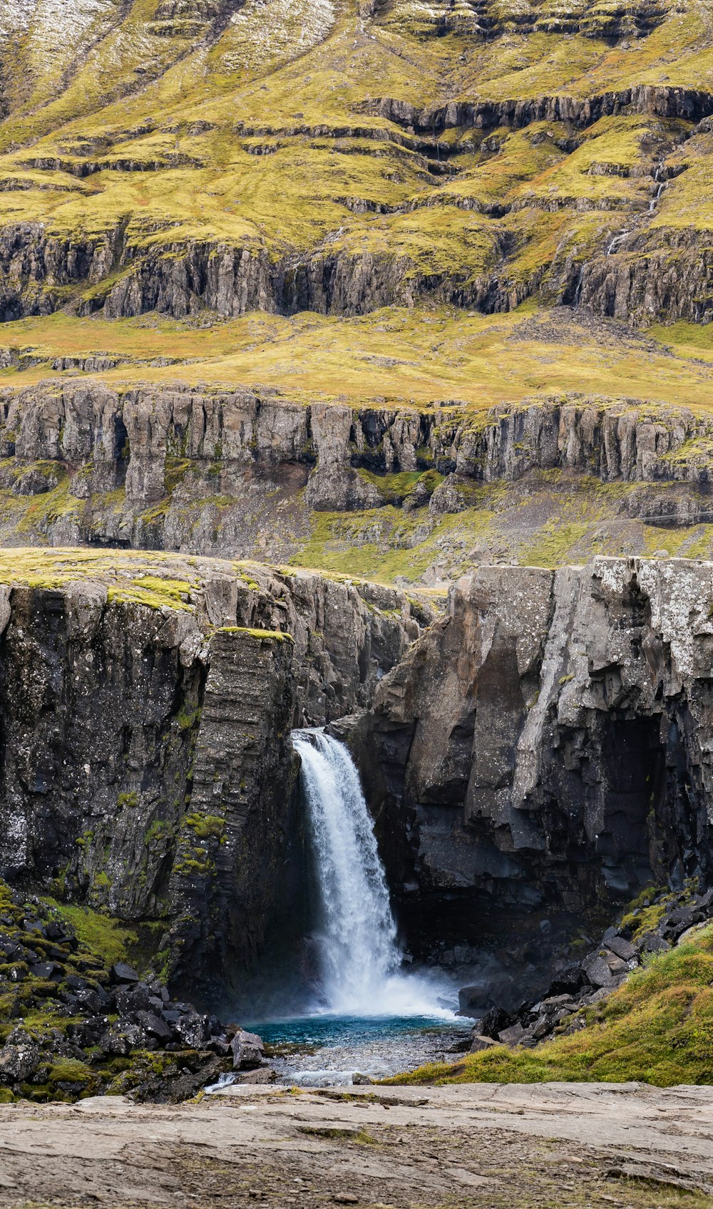 a waterfall in the middle of a rocky area