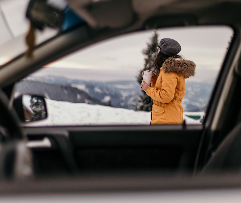 a woman in a car looking out the window