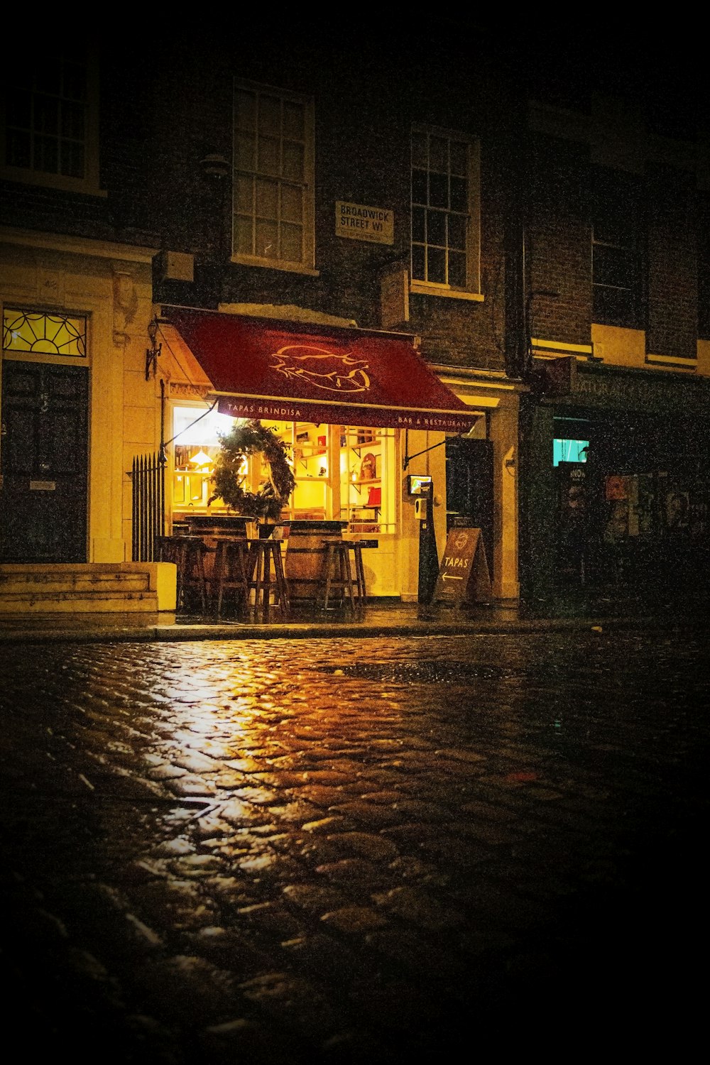 a storefront with a wreath on the front of it