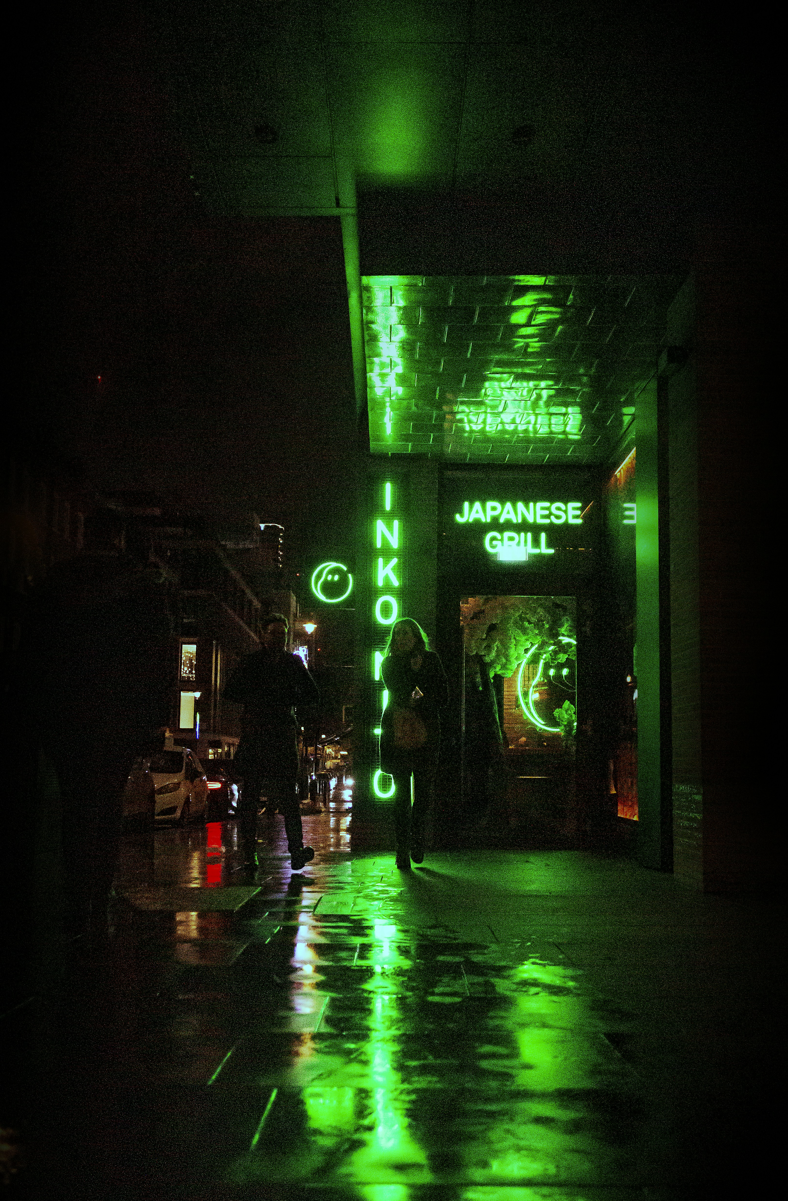 a person walking down a street at night