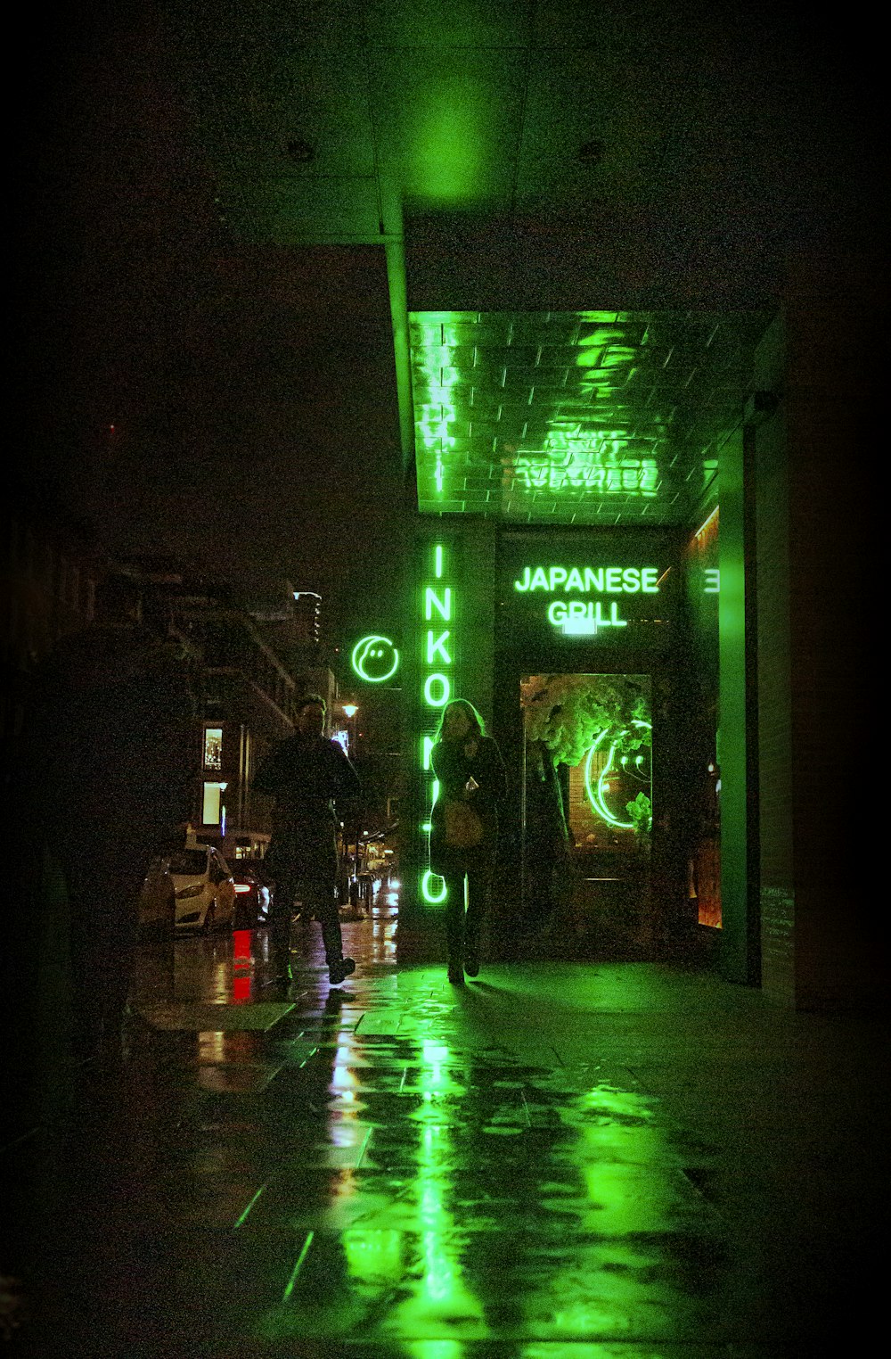 a person walking down a street at night