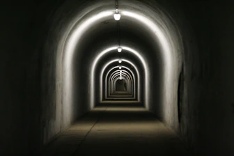 a dark tunnel with light at the end