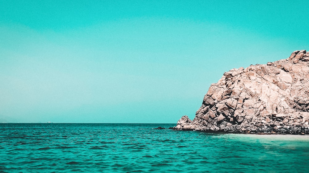 a rock outcropping in the middle of the ocean