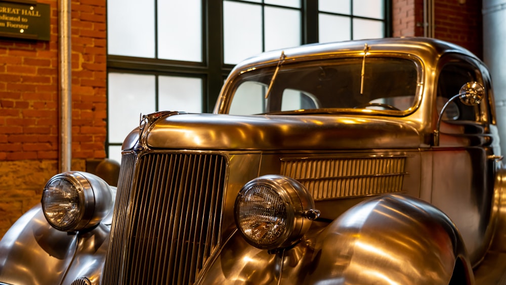 a shiny antique car is parked in a building
