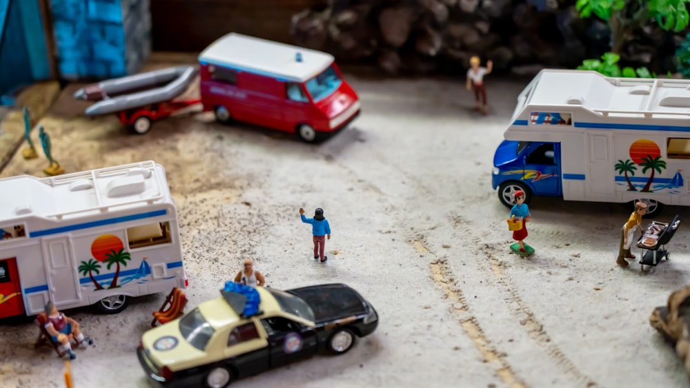 a group of toy vehicles and people on a road